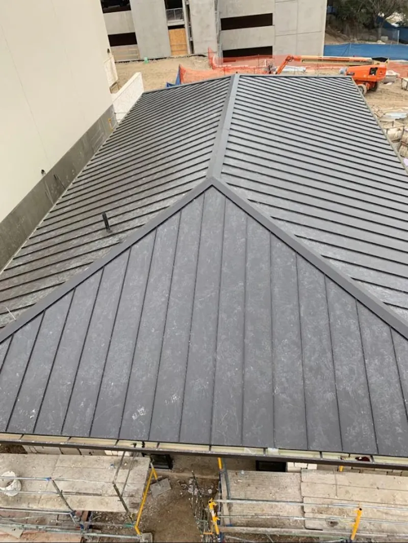 Commercial metal roof construction with crane equipment in Cape St. Claire